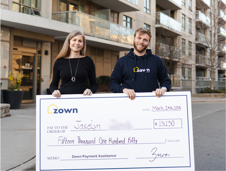 A Zown representative in a Zown shirt and client Jaselyn holding a $15,150 down payment check awarded on March 24, 2024.