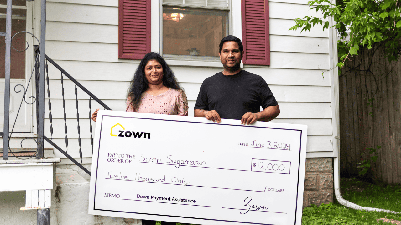 Suren and Marina holding a check from Zown for $12,000
