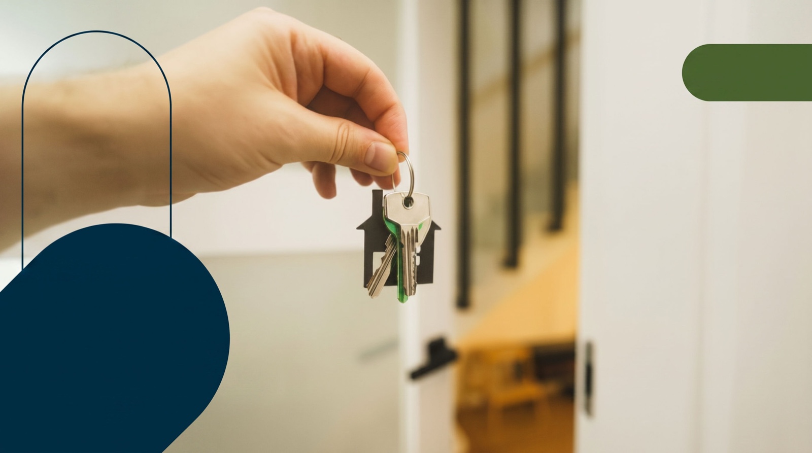 A hand holding house keys on a home-shaped keychain in a doorway on closing day for an Ontario home purchase.