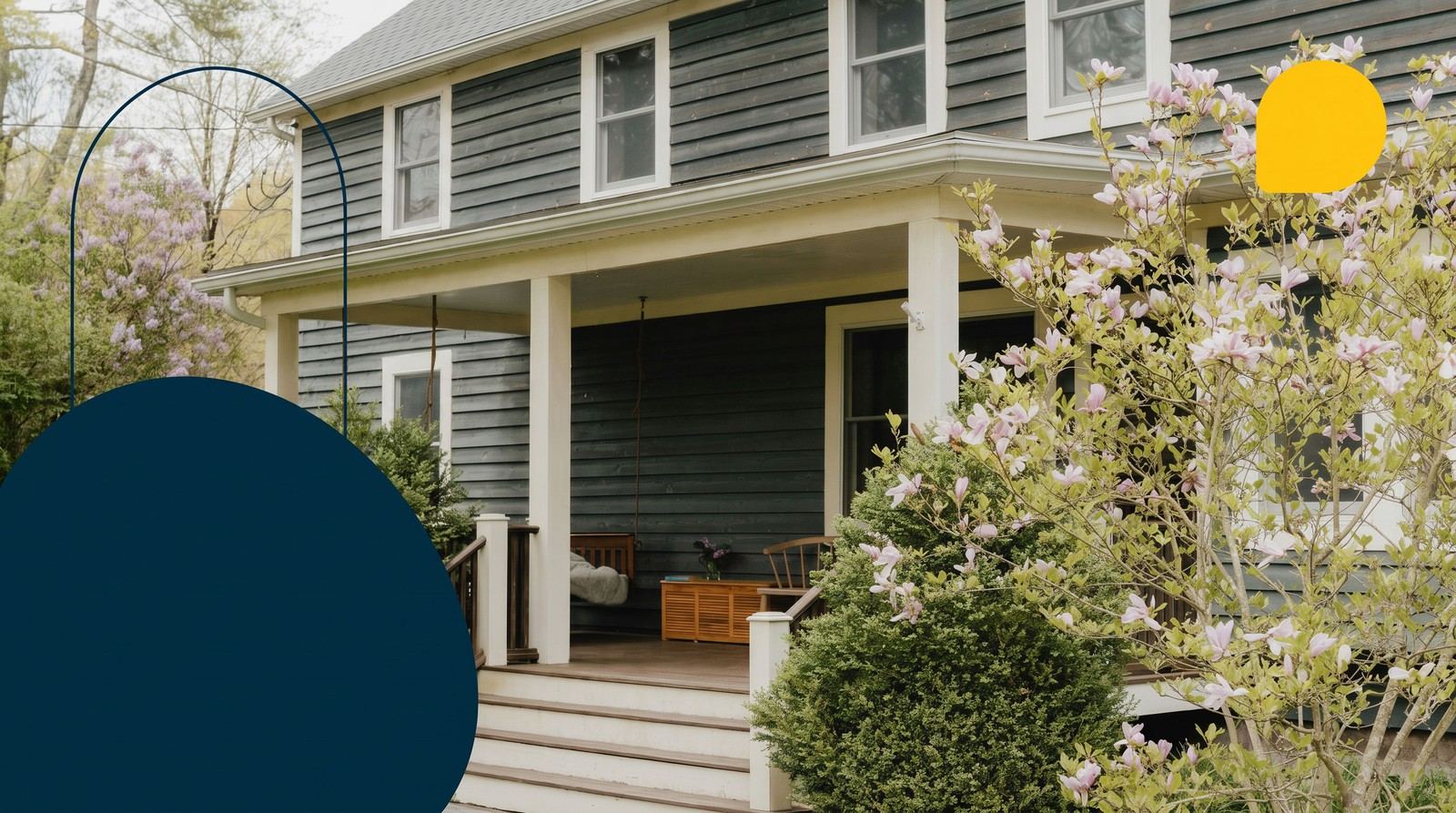 A first home with a covered front porch and blossoming trees in spring