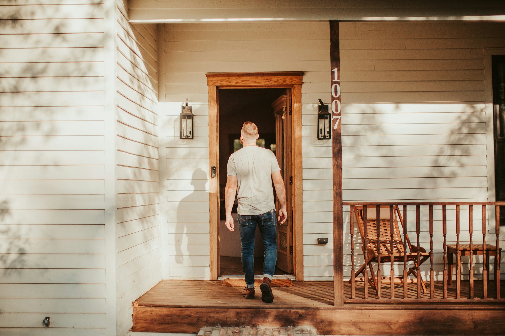 Person walking alone through the front door of a house for an open house viewing