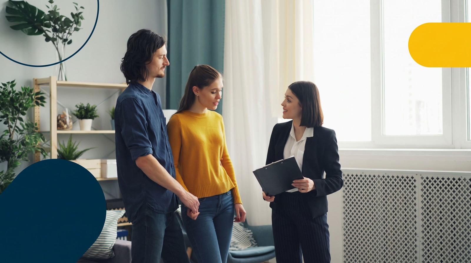 A real estate agent showing a home to a young couple in a bright living room