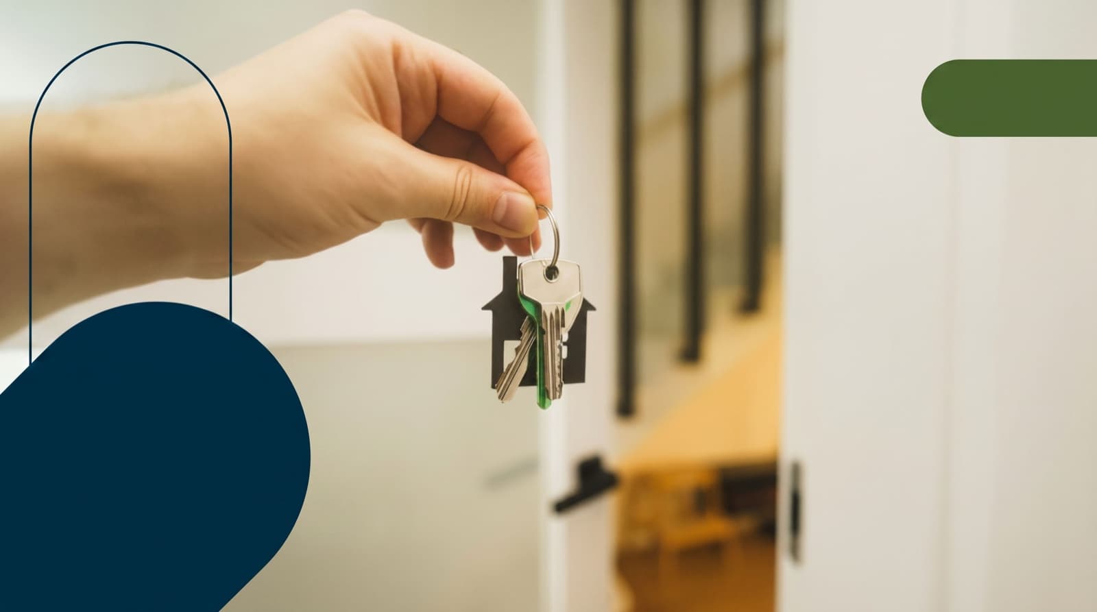 A hand holding house keys on a home-shaped keychain in a doorway on closing day for an Ontario home purchase.