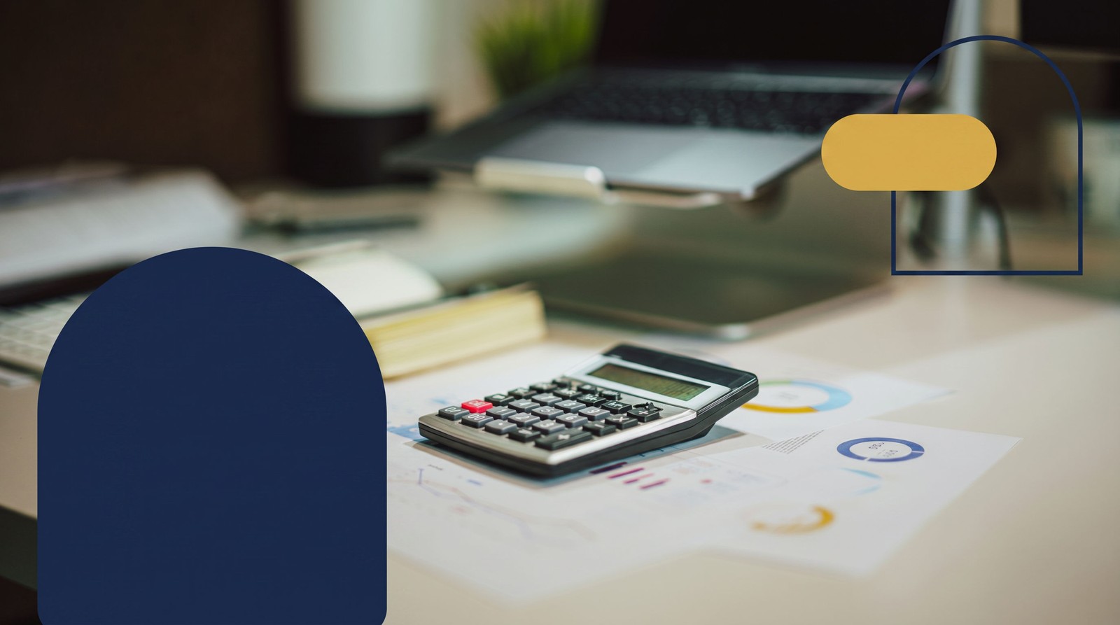 A calculator resting on financial charts beside an open laptop on a desk, illustrating gathering documents for a mortgage pre-approval in Ontario.