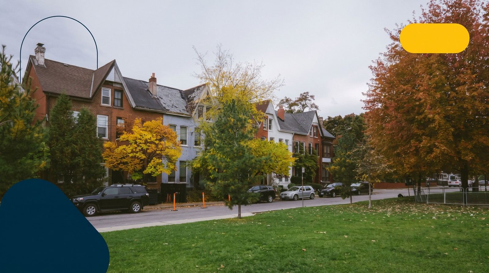 A row of brick Victorian houses on a tree-lined Toronto street in autumn