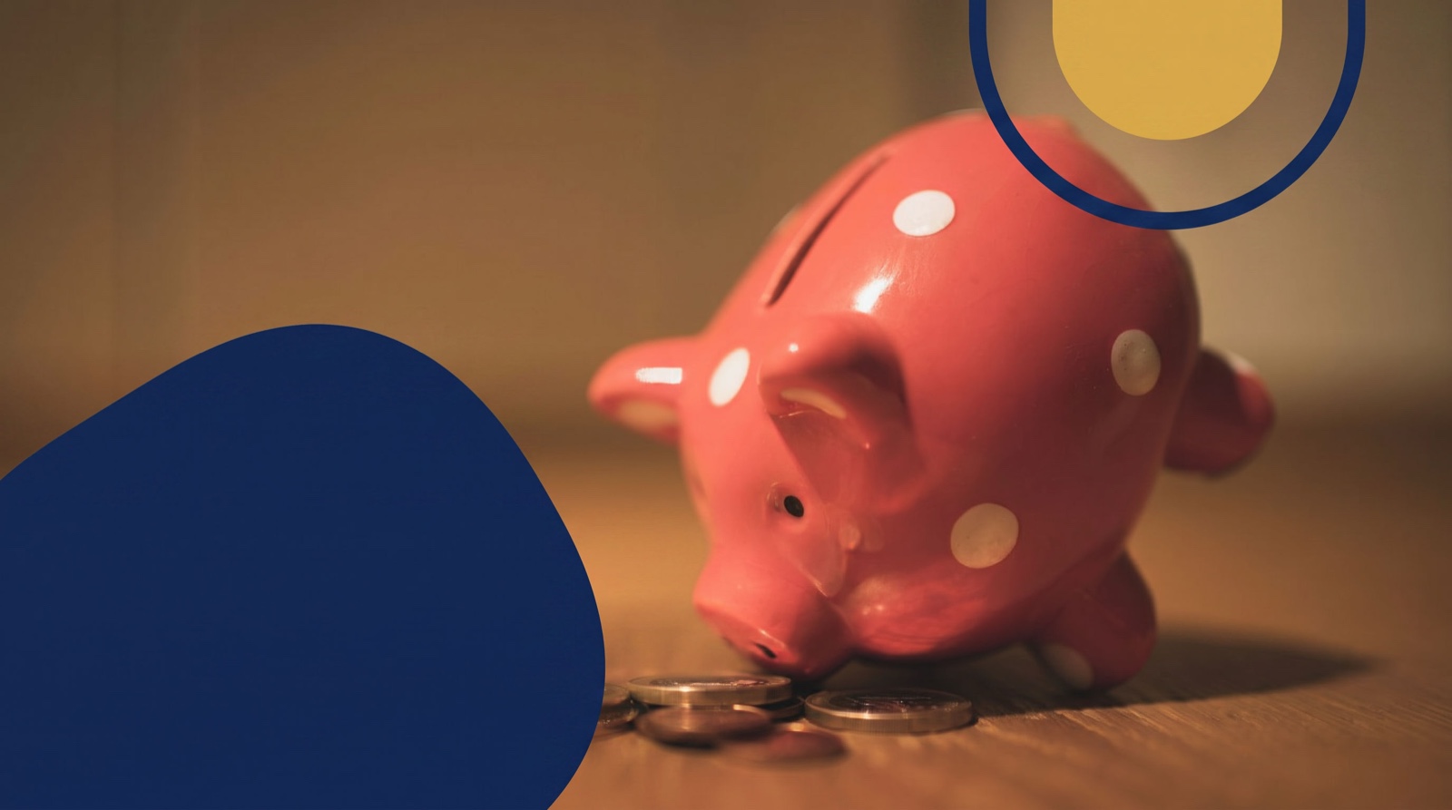 A pink polka-dot piggy bank beside a few coins, representing saving a down payment through the RRSP Home Buyers' Plan.